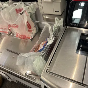 a conveyor belt with bags of food on it