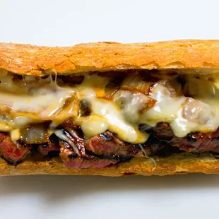 a steak sandwich with cheese