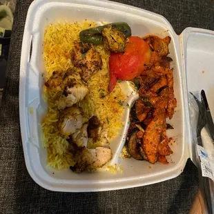 Chicken kabob with rice and potatoes.