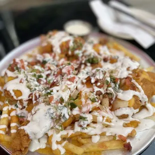 Fully Loaded Chicken Tender Fries (fries topped with melted cheeses, our crispy chicken tenders, crumbled bacon, jalapenos pico de gallo)