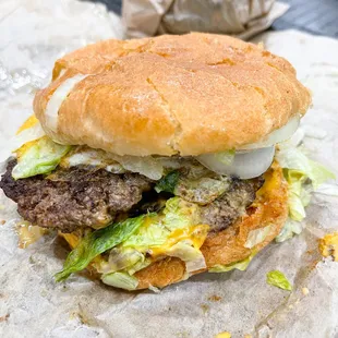 a hamburger with lettuce and cheese
