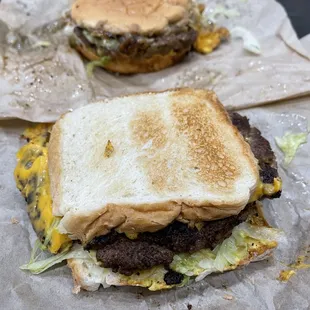 two burgers on wax paper