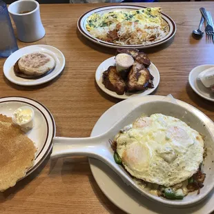 a breakfast of eggs, pancakes, and sausage