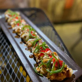 a long sushi on a plate