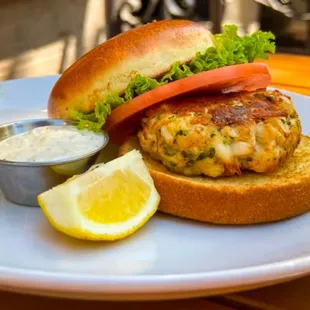 a crab burger with lettuce and tomato