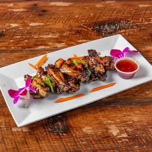 a plate of chicken skewers