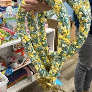 Popcorn Lei order for Punahou. Blue and yellow, mix colored with gold ribbon