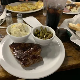 8 oz. medium-well steak with potato salad, green beans, and a drink. As well as the other food we ordered in the background. :)
