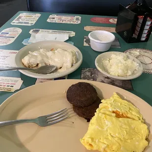 Scrambled eggs cheese two patties grits and biscuits and gravy