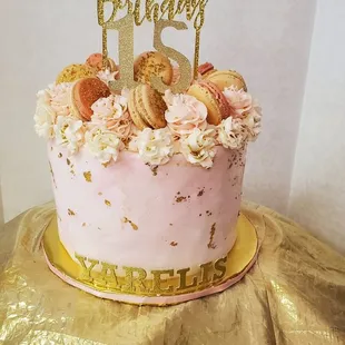 a pink and gold birthday cake
