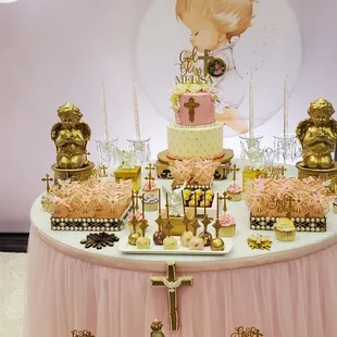 a table with a cake and cupcakes