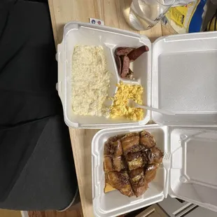 Cinnamon role pancakes and grits , eggs , and sausage.