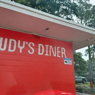 a red building with a sign that says judy&apos;s diner