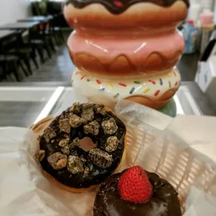 a chocolate covered donut and a strawberry
