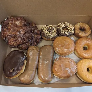 One dozen donuts with upcharge for apple fritters for total of twenty three dollars