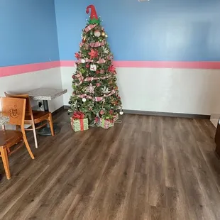 a christmas tree in the corner of the room