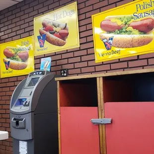 a vending machine in front of a red brick wall