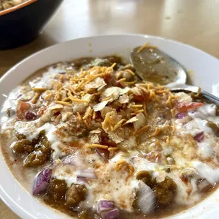 Alloo Tikki Chaat: Spiced potato patties topped with chickpeas, yogurt, tamarind, and mint chutneys.