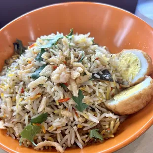 Chicken Biryani:  Basmati rice cooked with chicken, onions, garlic, ginger, spices with raita.