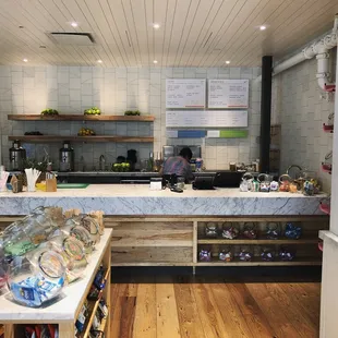 a kitchen with a counter and shelves