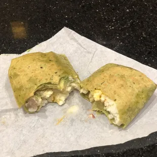 Delicious monster egg with avocado and turkey wrap in spinach wrap
