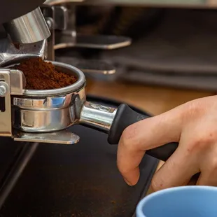 a person using a coffee grinder