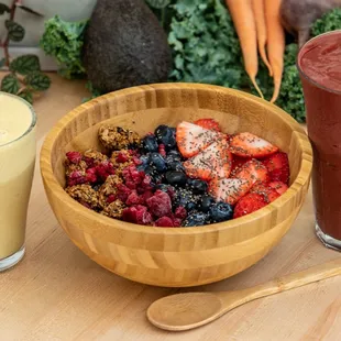 a bowl of fruit and a glass of smoothie