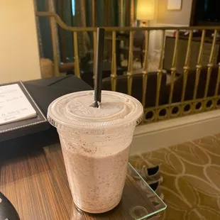 a smoothie in a plastic cup