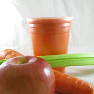 an apple, carrots, and celery