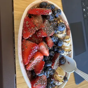 a bowl of strawberries, blueberries, bananas and chia seeds
