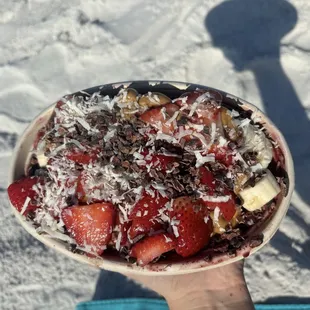Acai bowl with strawberry, banana, peanut butter, coconut, and cacao nibs