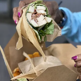 a woman putting a wrap in a box