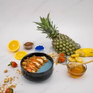 a bowl of fruit and a pineapple