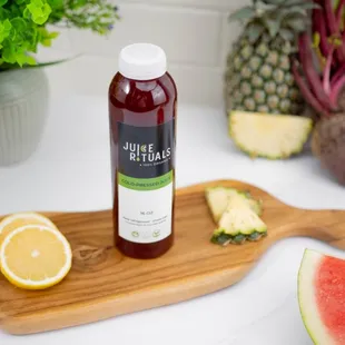 a bottle of juice on a cutting board
