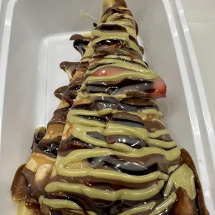 Strawberry banana crêpe with Nutella, dark chocolate and pistachio sauce