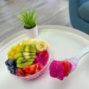 a bowl of fruit and a spoon of fruit
