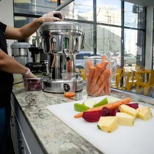 a woman preparing fruit and vegetables