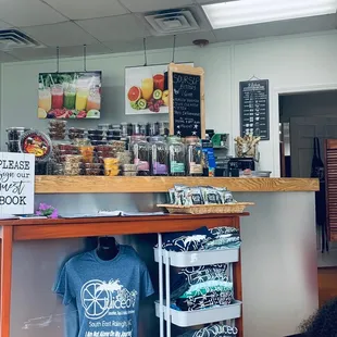 a store counter with a variety of drinks