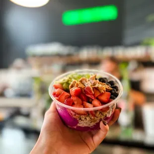 a person holding a bowl of fruit