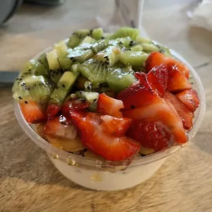 Coconut base with kiwi and strawberries topped with a drizzle of agave