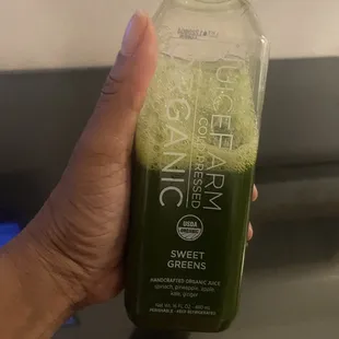 a person holding a bottle of juice