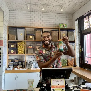 a man holding a jar of juice