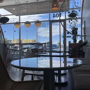 a table and chairs in front of a large window