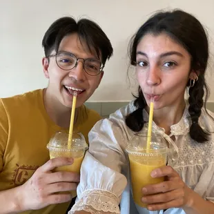 a man and a woman holding drinks