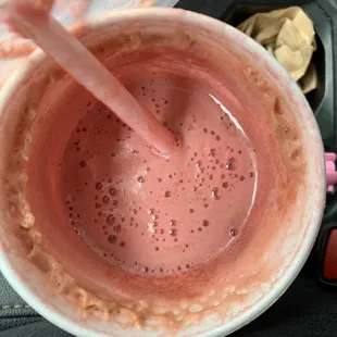 a pink drink in a cup