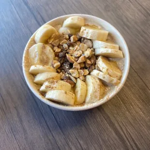Oatmeal Bowl with oatmeal, cinnamon, almond milk, agave or honey. Topped with banana, raisins, and almonds.
