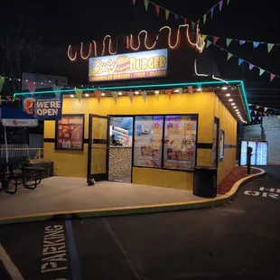 a neon sign for juicy burger