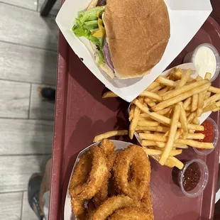Junior juicy cheeseburger with ranch and bbq sauce, fries, and onion rings