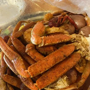 a pile of crab legs and sausages