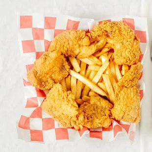 a basket of fried fish and french fries